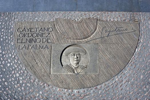 Engraving above cement in honor of the Spanish Bullfighter Cayetano Ordoñez y Aguilera, known as El Niño de la Palma, near the bullring of Ronda, Malaga Province, Andalucia, Spain