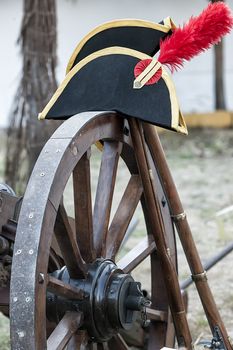 Detail of Napoleonic hat on the wheel of a canon during Representation of the Battle of Bailen, Bailen  Jaen province, Andalusia, Spain