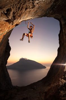 Rock climber falling of a cliff while lead climbing, climber slightly blurred due to motion