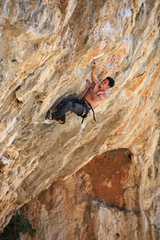 Rock climber on a face of a cliff. Kalymnos Island, Greece.