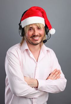 Caucasian man wearing headset with christmas hat in studio
