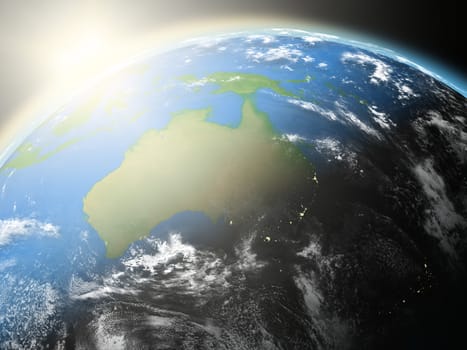 Space view of the sun rising over Australia on blue planet Earth. Elements of this image furnished by NASA.