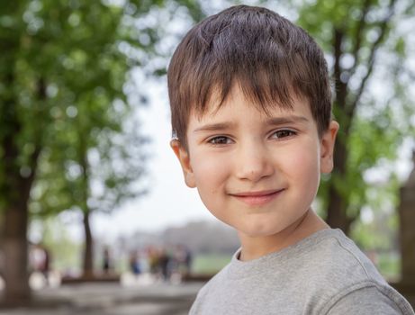 Happy little boy smiling on blurred background