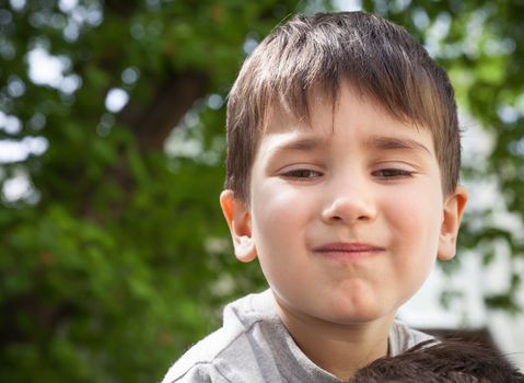 Happy little boy smiling on blurred background