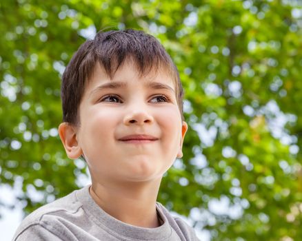 Happy little boy smiling on blurred background