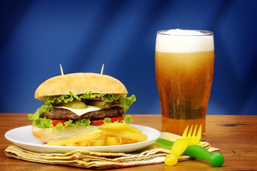 Close up of big tasty burger, french fries and beer 