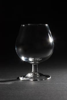 Single glass at dark background