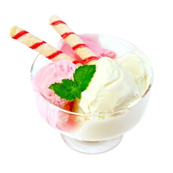 Pink and white ice cream with wafer rolls and mint in glass isolated on white background