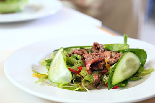 Salad with a beef on the table