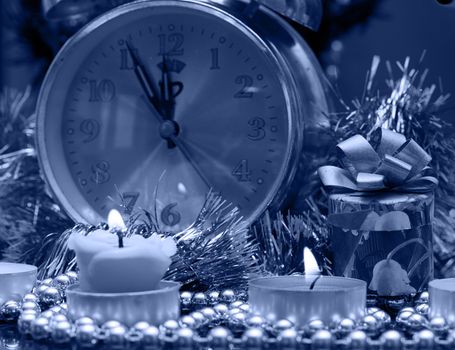 Candle on the background of the Christmas tree and gifts