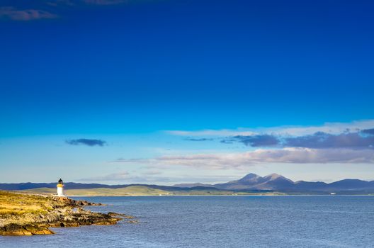 Ocean coast lighthouse in Port Charlotte, Scotland, United Kingdom