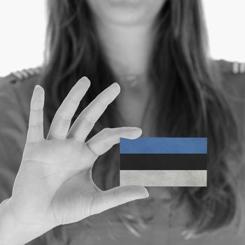 Woman showing a business card, flag of Estonia