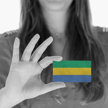 Woman showing a business card, flag of Gabon