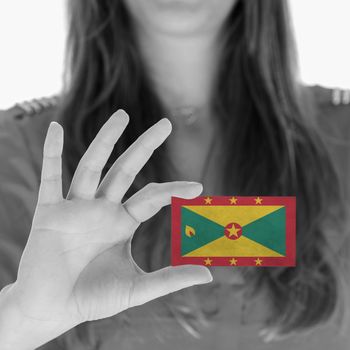 Woman showing a business card, flag of Grenada