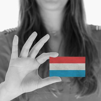 Woman showing a business card, flag of Luxembourg