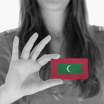 Woman showing a business card, flag of Maldives