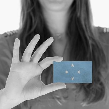 Woman showing a business card, flag of Micronesia