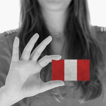 Woman showing a business card, flag of Peru