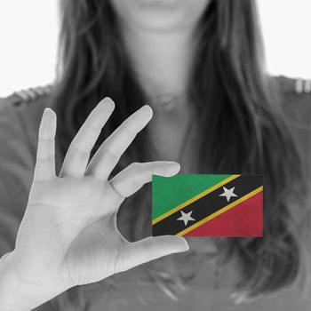 Woman showing a business card, flag of Saint Kitts and Nevis