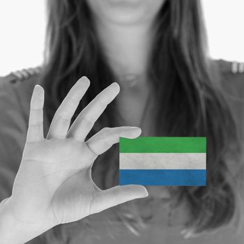 Woman showing a business card, flag of Sierra Leone