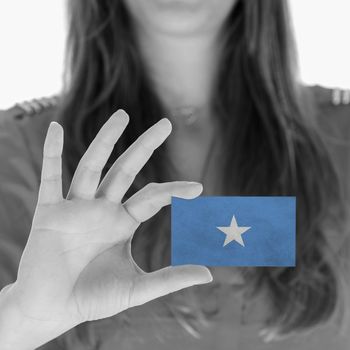 Woman showing a business card, flag of Somalia