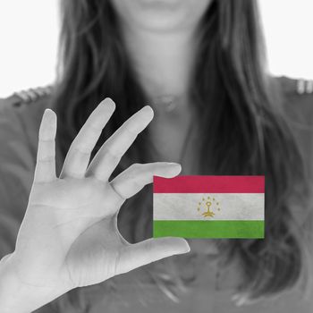 Woman showing a business card, flag of Tajikistan