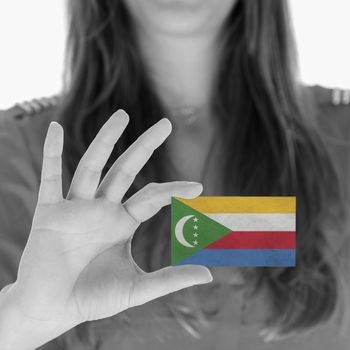Woman showing a business card, flag of The Comoros
