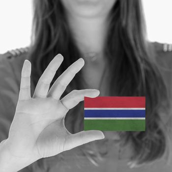 Woman showing a business card, flag of The Gambia