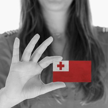 Woman showing a business card, flag of Tonga