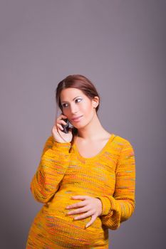 portrait of pregnant woman using cell phone