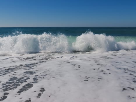 White waves rolled on the Mediterranean Sea coast during a storm