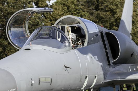 Detailed view of a fighter jet airplane cockpit.