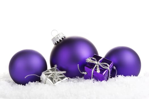 Christmas balls purple with presents on white background 