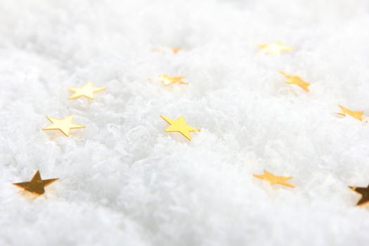 golden christmas stars on artificial snow 