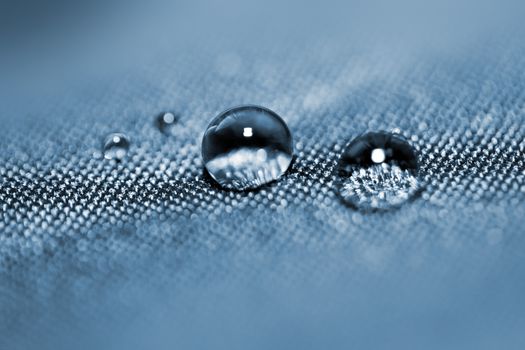 Effect with water drops on blue textile 