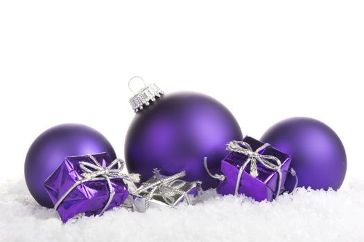 Christmas balls purple with presents on white background 