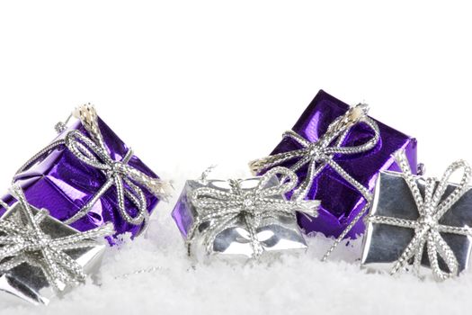 christmas presents purple and silver with snow and white background 