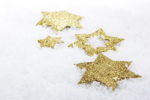 golden christmas stars on snow 