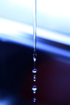 The fluid motion of water splashing as it is poured. 