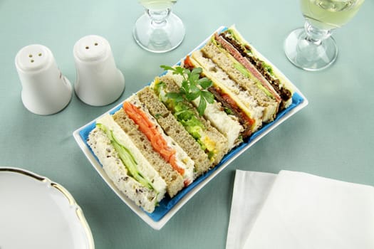 Freshly prepared assorted sandwiches cut without crusts.