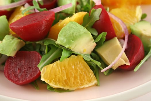 Beetroot avocado and orange salad background.