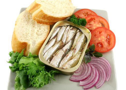 Sardines with bread, red onion, tomato, lettuce. and red basil.