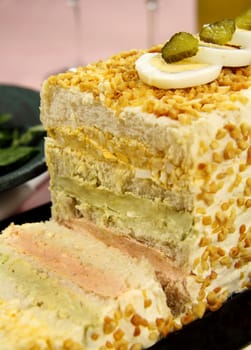 Layered salmon, avocado and curried egg loaf ready to serve.