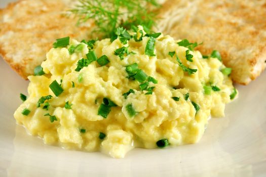 Scrambled eggs on turkish bread with shallots fennel and parsley.