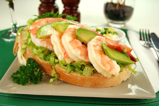 Delightful fresh shrimp and avocado open sandwich ready to serve.