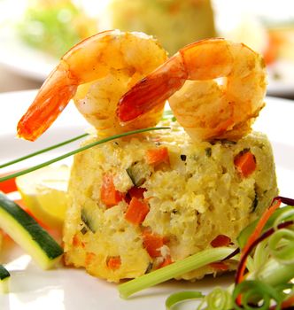 Delicious grilled shrimps on a risotto stack with side salad.