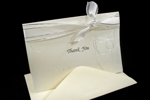 Silver embossed thank you card with bow.