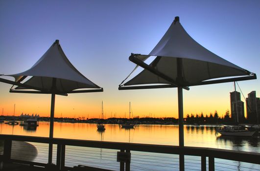 Main Beach Gold Coast Australia seen through shade sails at Southport just before dawn.