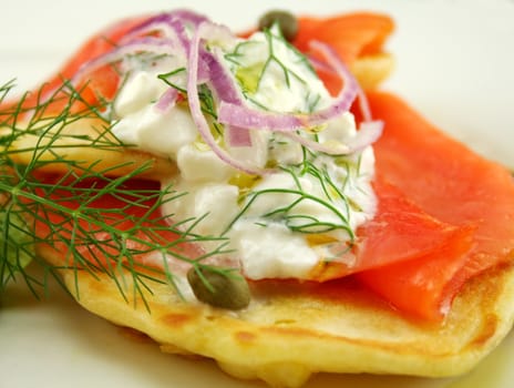 Corn fritters topped with smoked trout with dill, capers and cottage cheese.