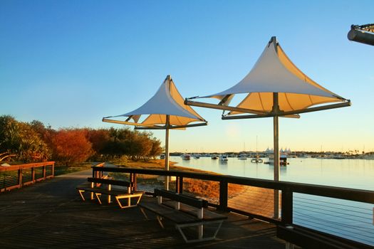 The Broadwater Gold Coast Australia seen through shade sails at Southport at dawn.